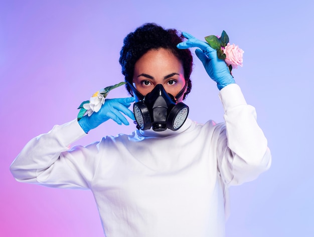 Free photo beautiful woman in floral gloves and respiratory mask