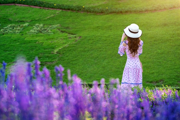 Beautiful woman on a flower garden.