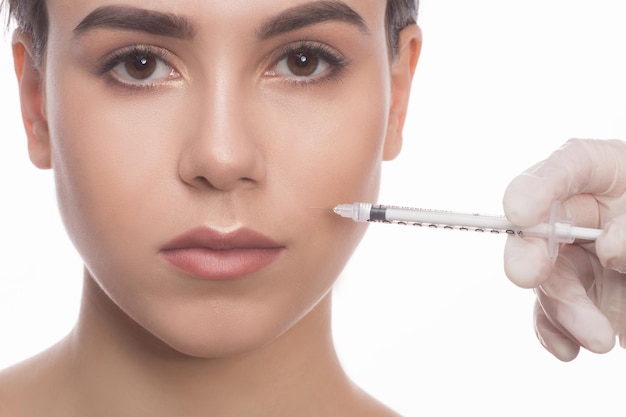 Beautiful woman getting beauty facial injections. Face aging injection.