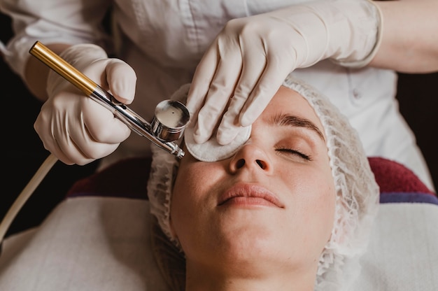 Beautiful woman getting a cosmetic treatment at the spa