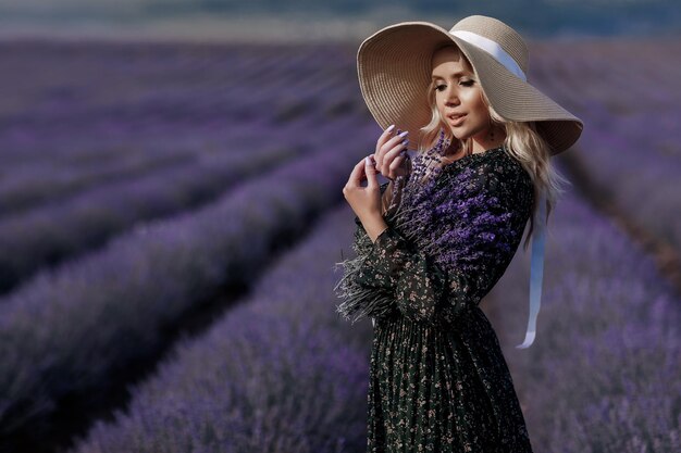 beautiful woman in hat in lavender field