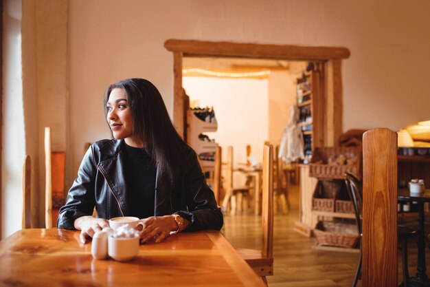 Beautiful woman having a cup of coffee in cafe