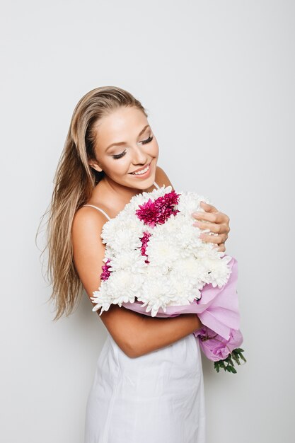 Beautiful woman holding bunch of flowers