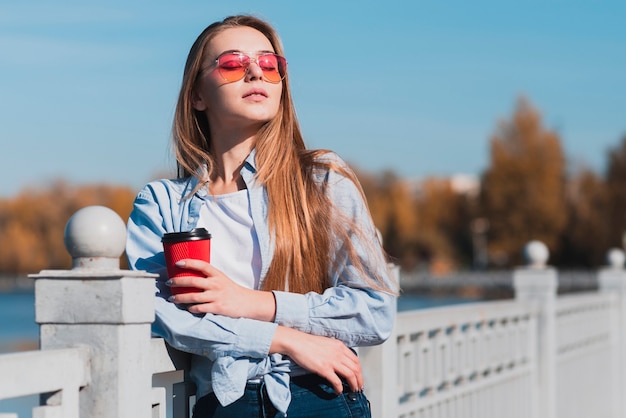 Free Photo beautiful woman holding a cup of coffee