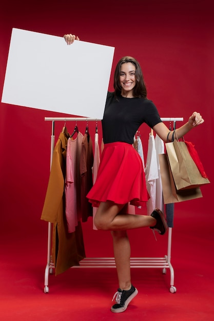 Free photo beautiful woman holding an empty banner