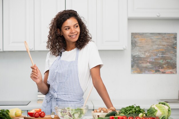 Beautiful woman holding a wooden spoon