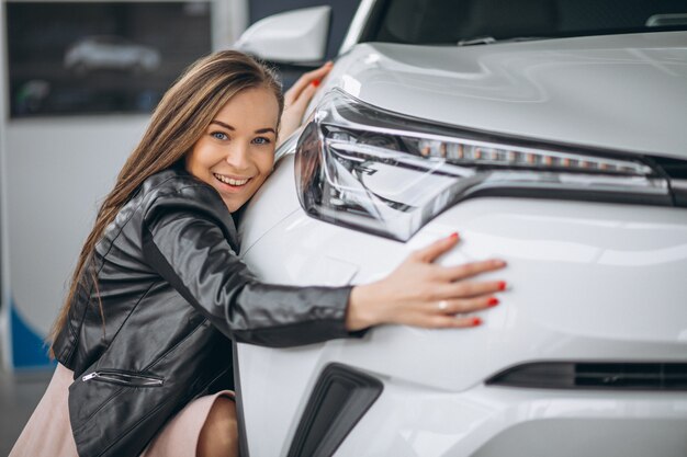 Beautiful woman hugging a car