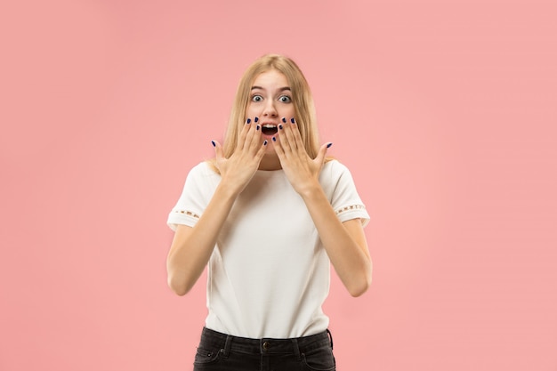 Beautiful woman looking suprised isolated on pink