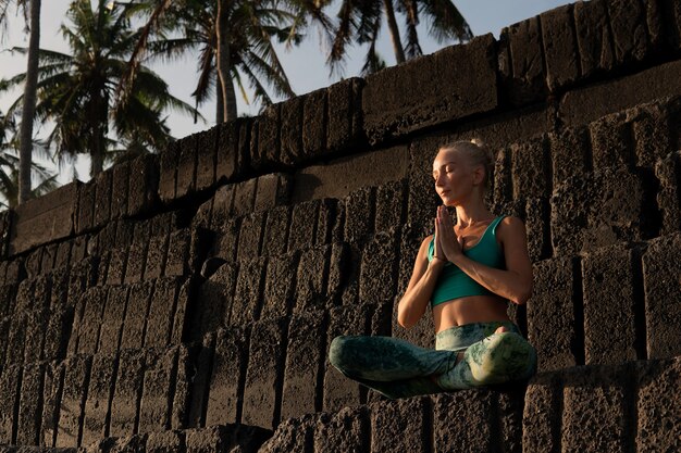 Beautiful woman meditating outdoors