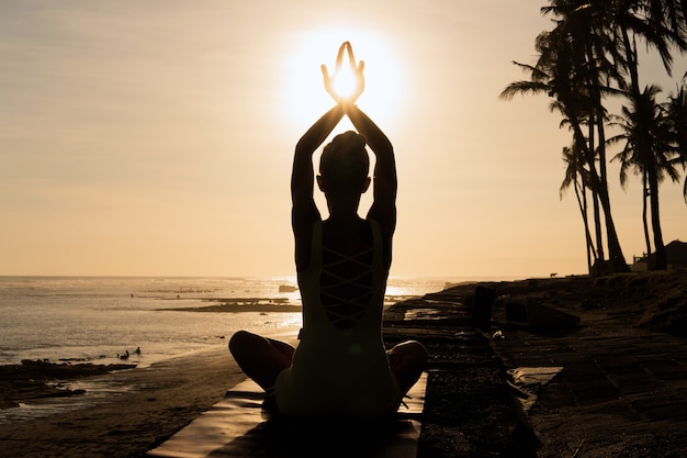 Beautiful woman meditating outdoors