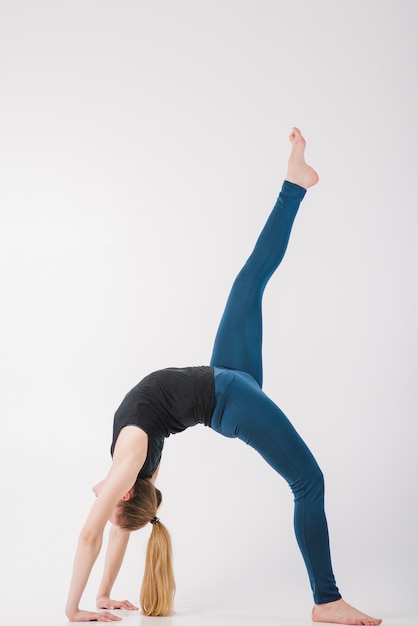 Beautiful woman meditating with leg up