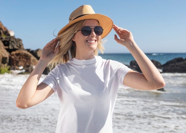 Free Photo beautiful woman in panama hat chilling at the beach