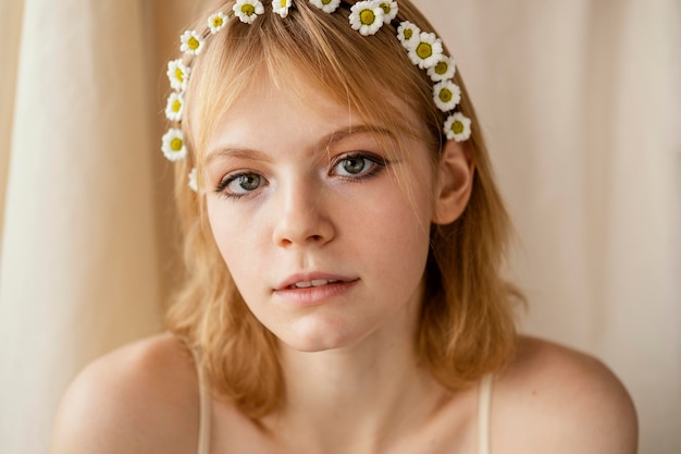 Free Photo beautiful woman posing while wearing a beautiful spring flowers crown