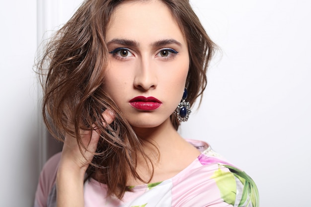 Beautiful woman posing with colorful floral dress