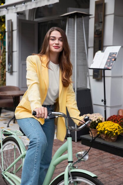 Beautiful woman posing with her bike on the street