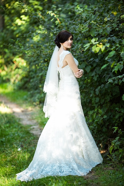 Beautiful woman posing with her wedding dress