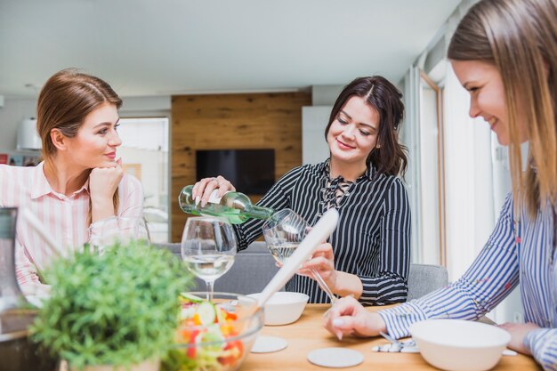 Beautiful woman pouring wine in glass