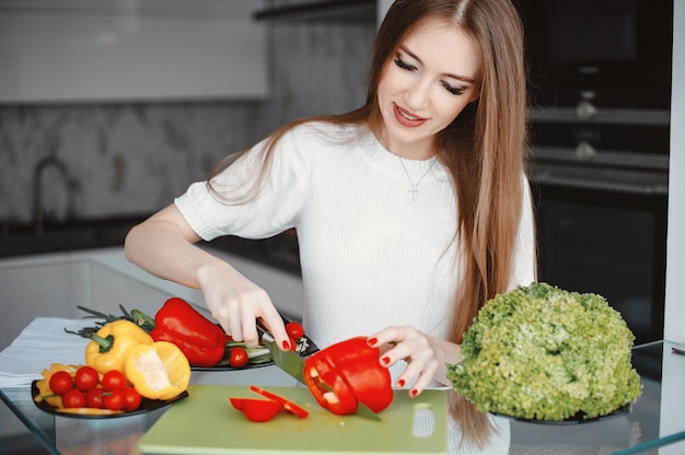 Beautiful woman prepare food in a kitchen