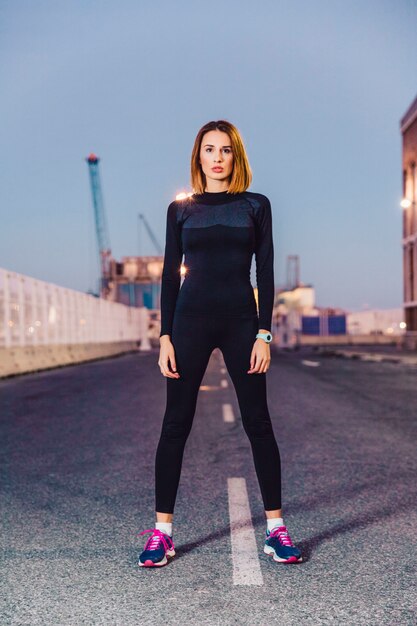 Beautiful woman on road looking at camera