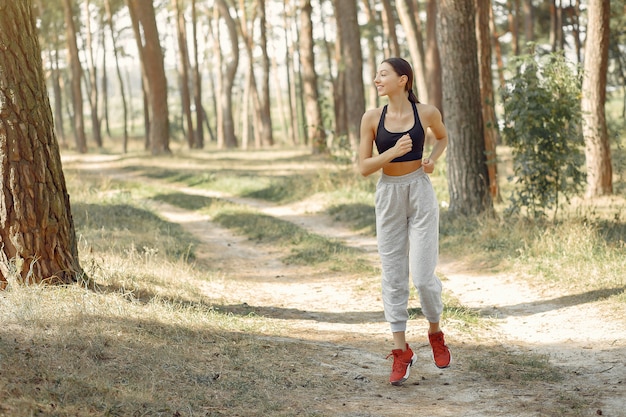 Beautiful woman runs in a summer park