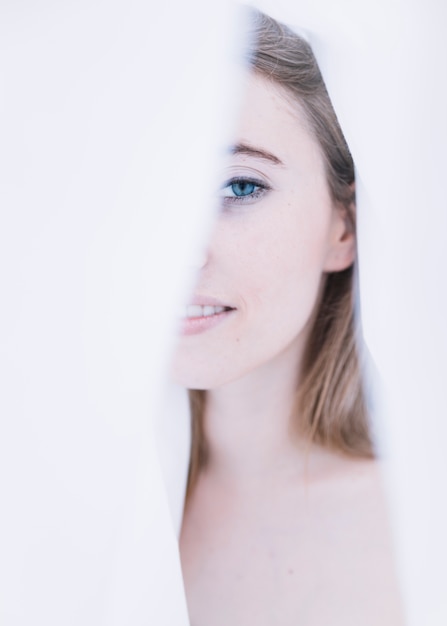 Free photo beautiful woman's face between white cloth