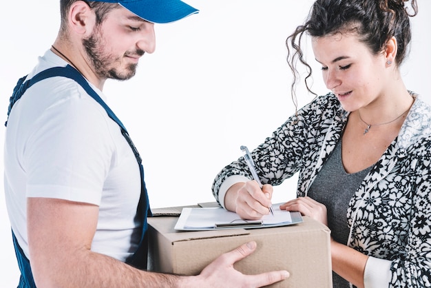 Beautiful woman signing for parcel