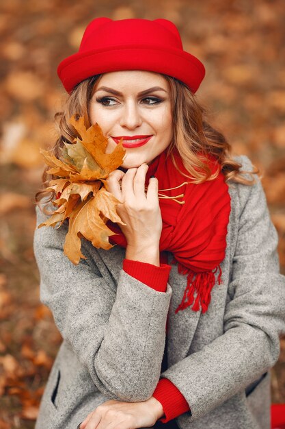 Beautiful woman sitting in a autumn park