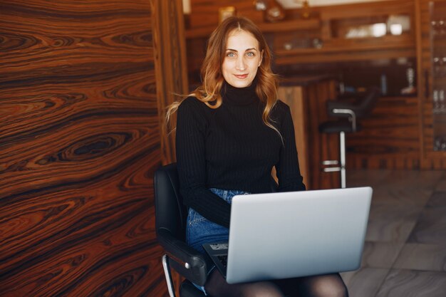 Beautiful woman sitting at home with laptop