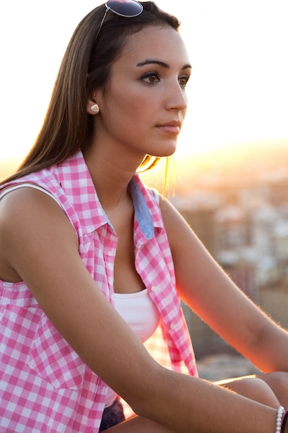 Beautiful woman sitting on the roof