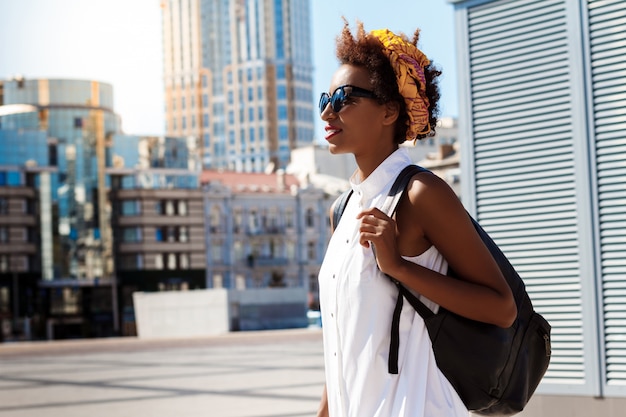 Beautiful woman smiling walking down city Fashion street style.