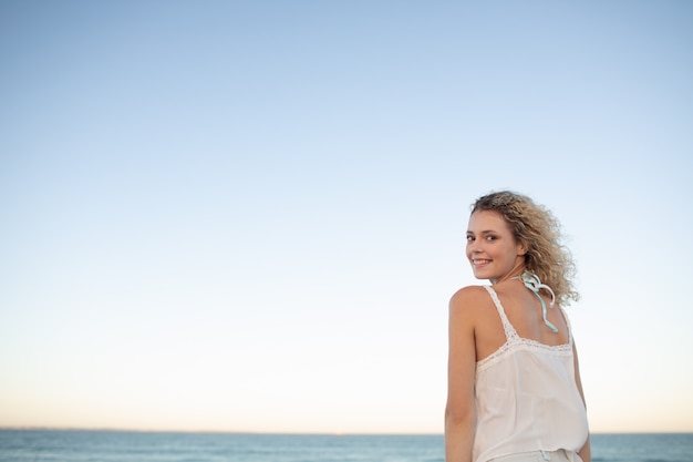 Beautiful woman standing on the beach