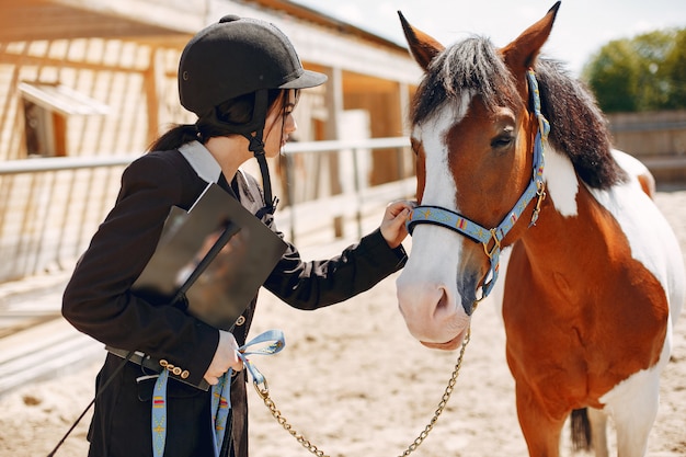 Beautiful woman standing with a horse