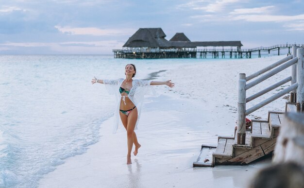 Beautiful woman in swim wear by the ocean