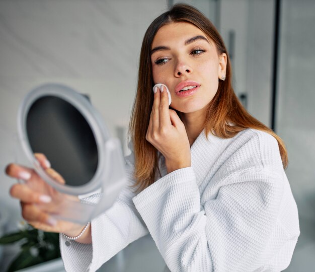 Beautiful woman taking care of her face