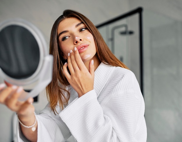 Beautiful woman taking care of her face