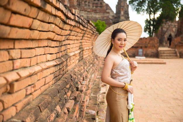 Beautiful woman in Thai old traditional costume , portrait at the ancient Ayutthaya temple.