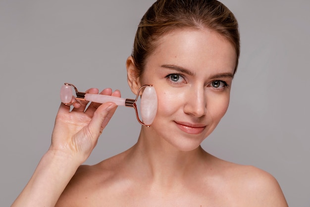 Beautiful woman using a jade roller