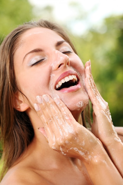 Beautiful woman washing her face