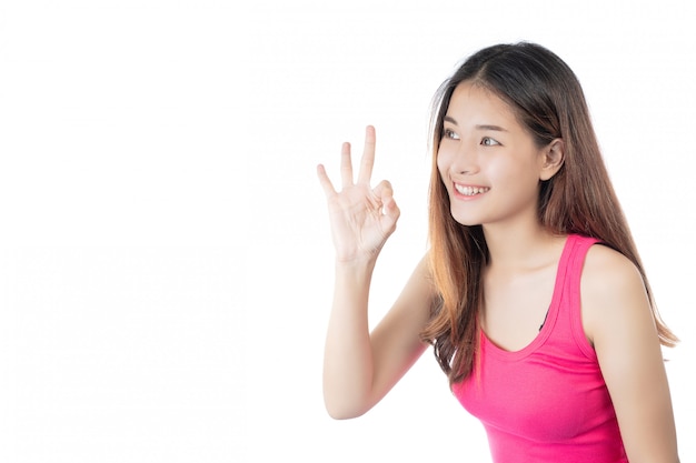 Beautiful woman wearing a pink shirt with a happy smile on a white background