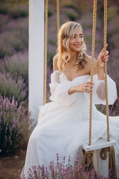 Free photo beautiful woman in wedding dress in lavender field