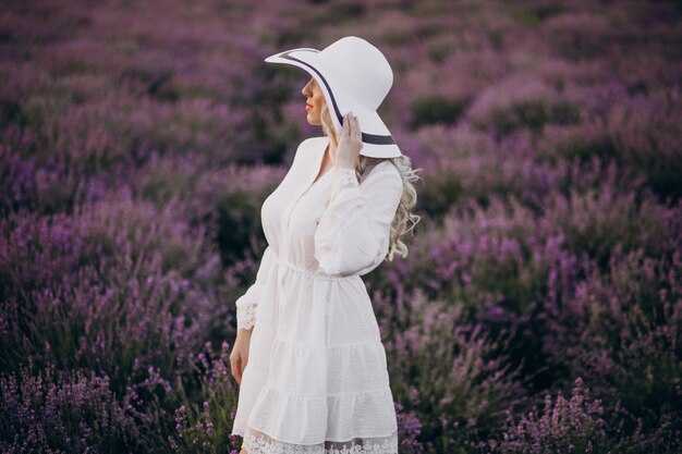 Beautiful woman in white dress in a lavander field