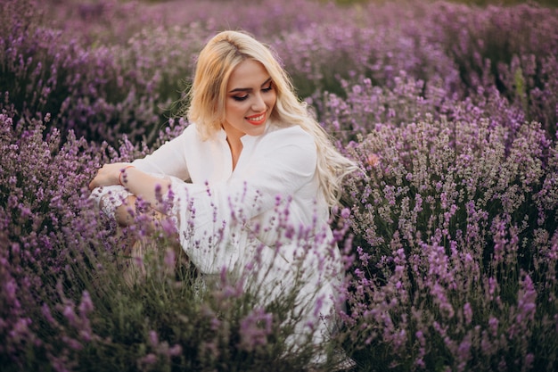 Beautiful woman in white dress in a lavander field