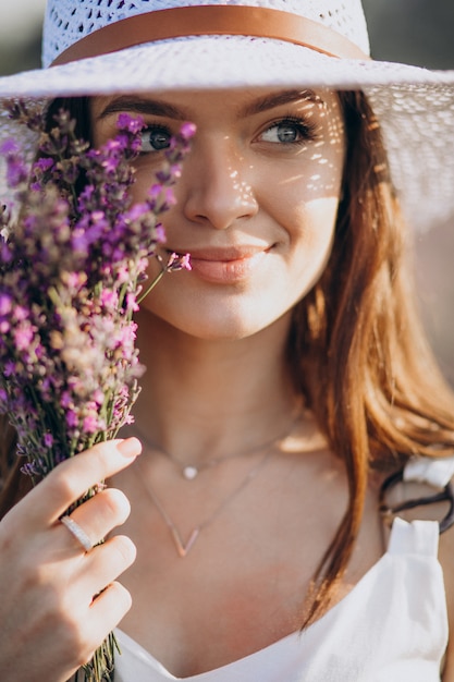 Beautiful woman in white dress in a lavander field