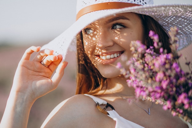 Beautiful woman in white dress in a lavander field