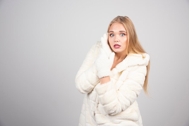 Beautiful woman in winter outfit posing