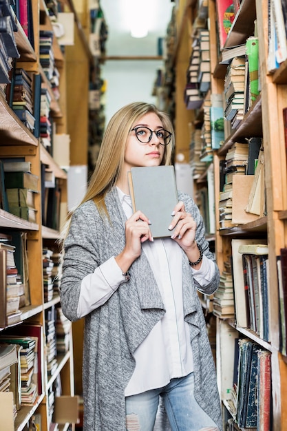 Free photo beautiful woman with book thinking