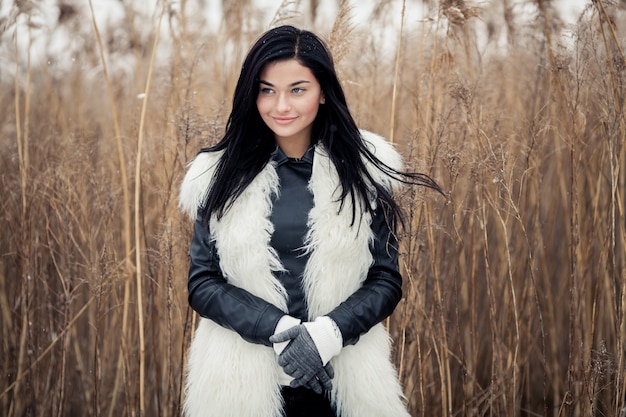 Beautiful woman with a coat in the nature