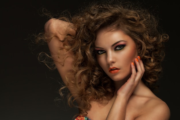 Free photo beautiful woman with curls and makeup