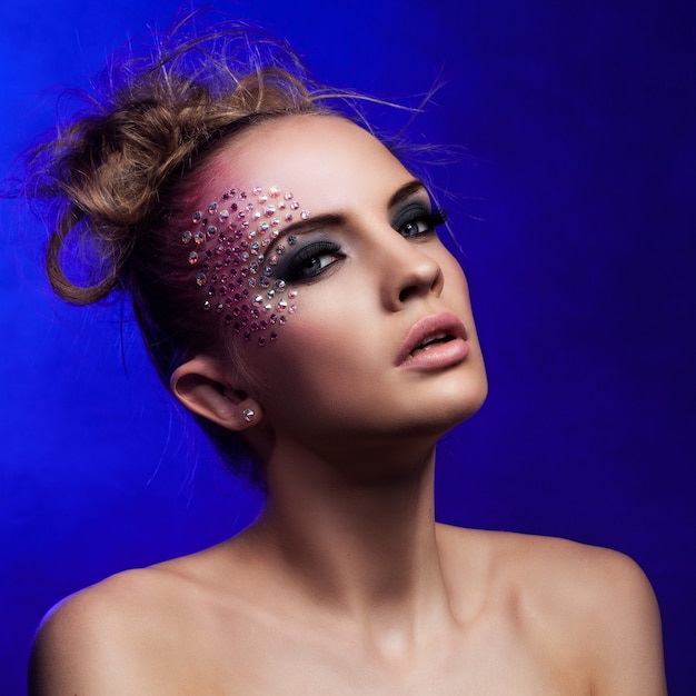 Free photo beautiful woman with fantasy makeup