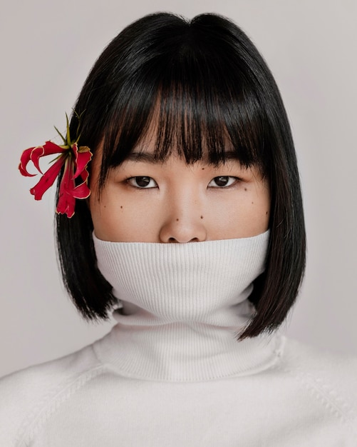 Beautiful woman with flower over ear